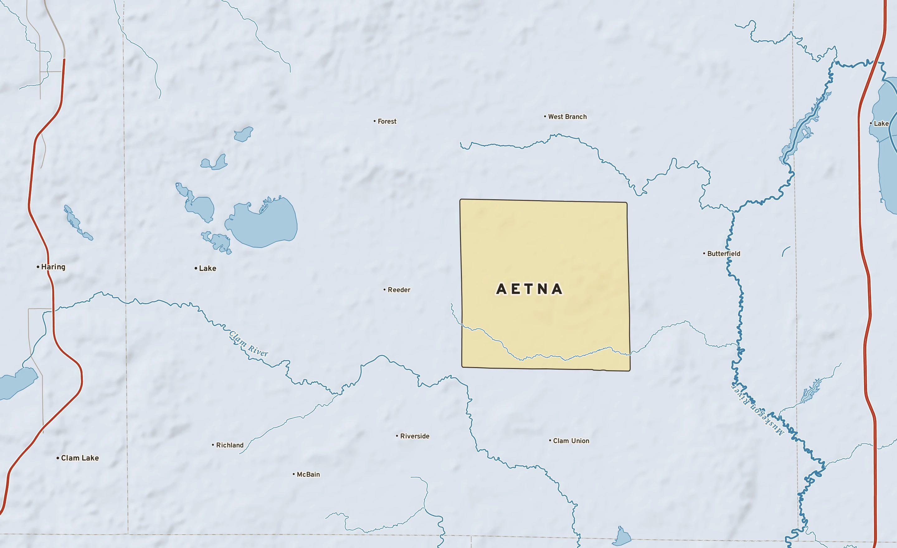 Shaded-relief atlas plate of Aetna, Michigan: rivers, roads, the city limits and where the water drains.