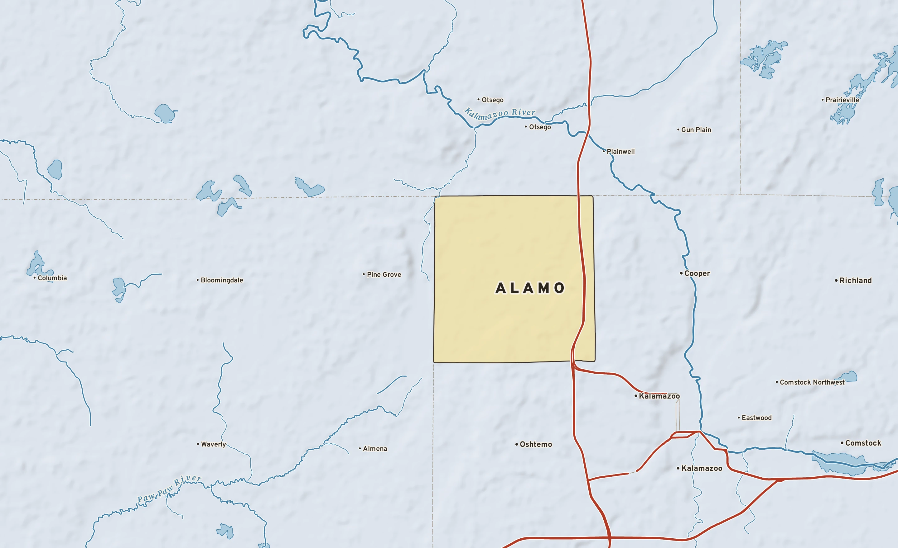 Shaded-relief atlas plate of Alamo, Michigan: rivers, roads, the city limits and where the water drains.