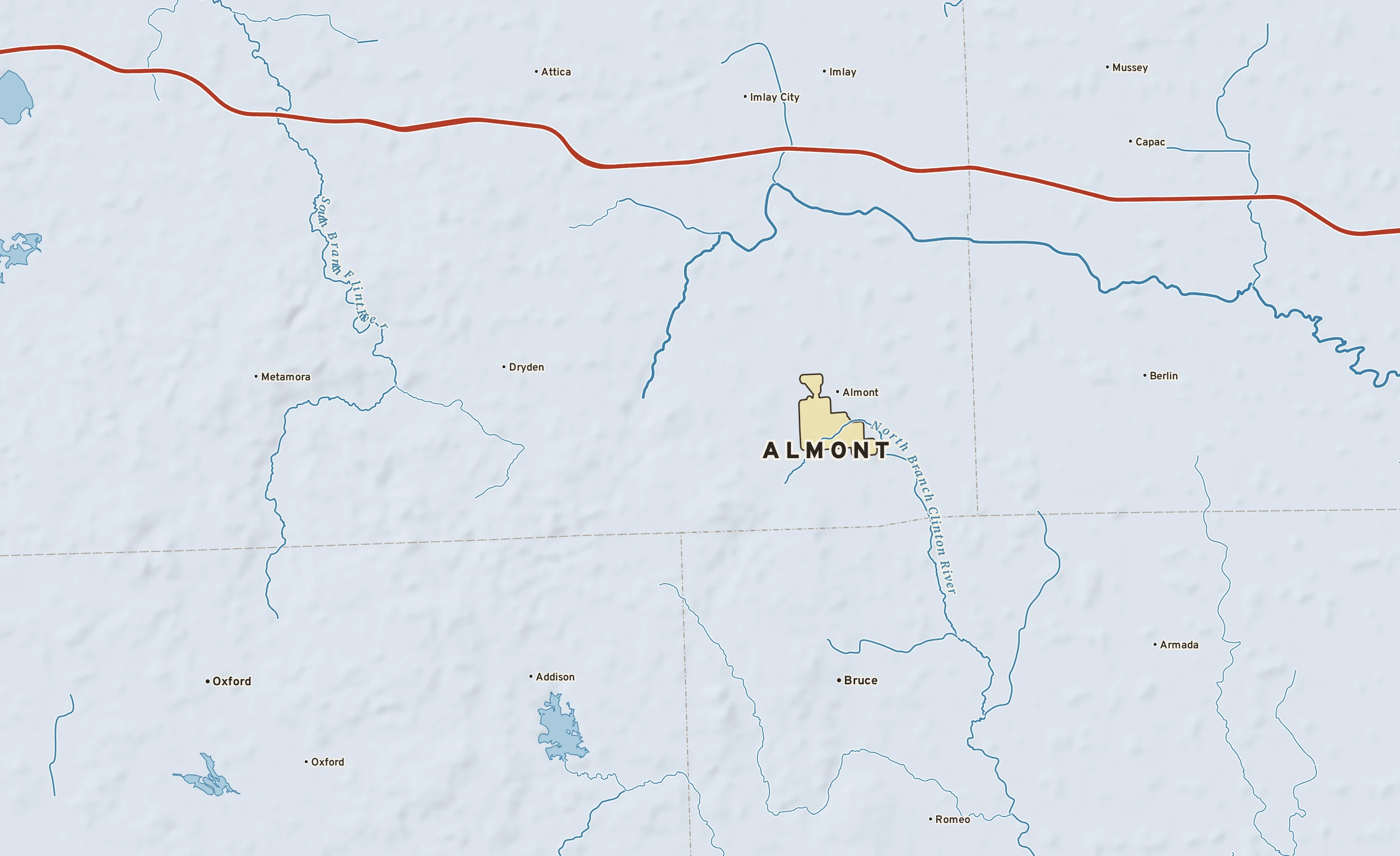 Shaded-relief atlas plate of Almont, Michigan: rivers, roads, the city limits and where the water drains.
