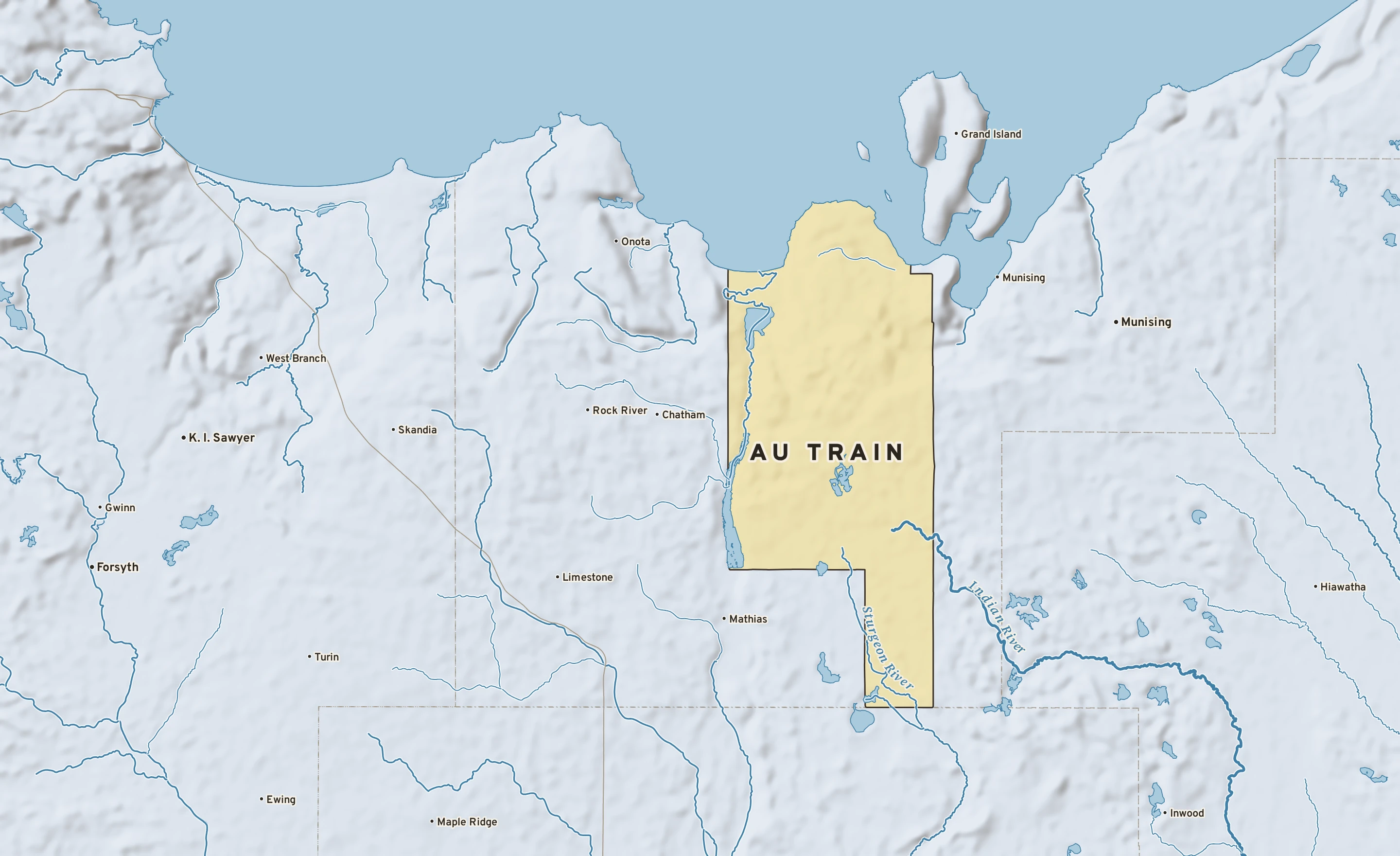 Shaded-relief atlas plate of Au Train, Michigan: rivers, roads, the city limits and where the water drains.