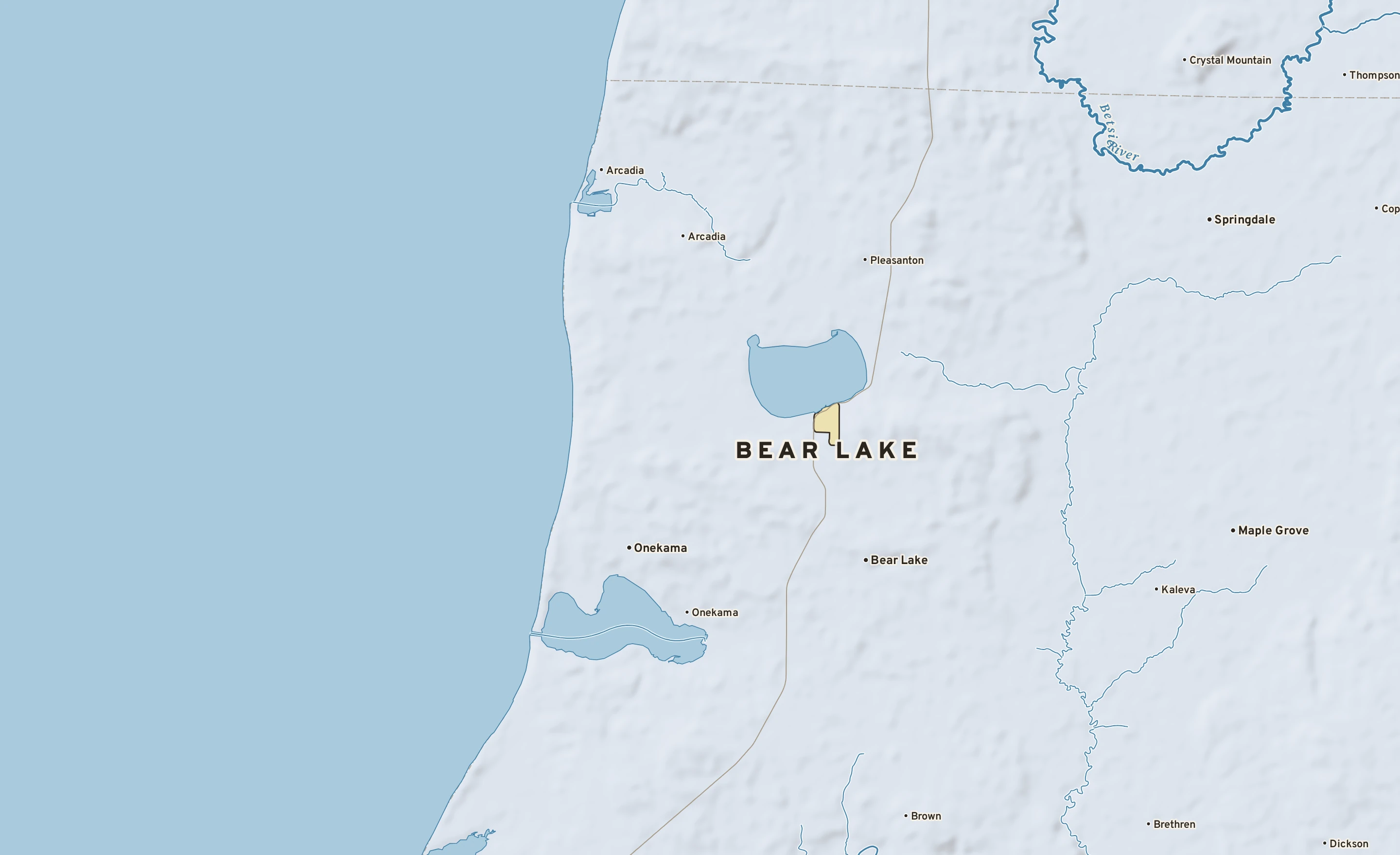 Shaded-relief atlas plate of Bear Lake, Michigan: rivers, roads, the city limits and where the water drains.
