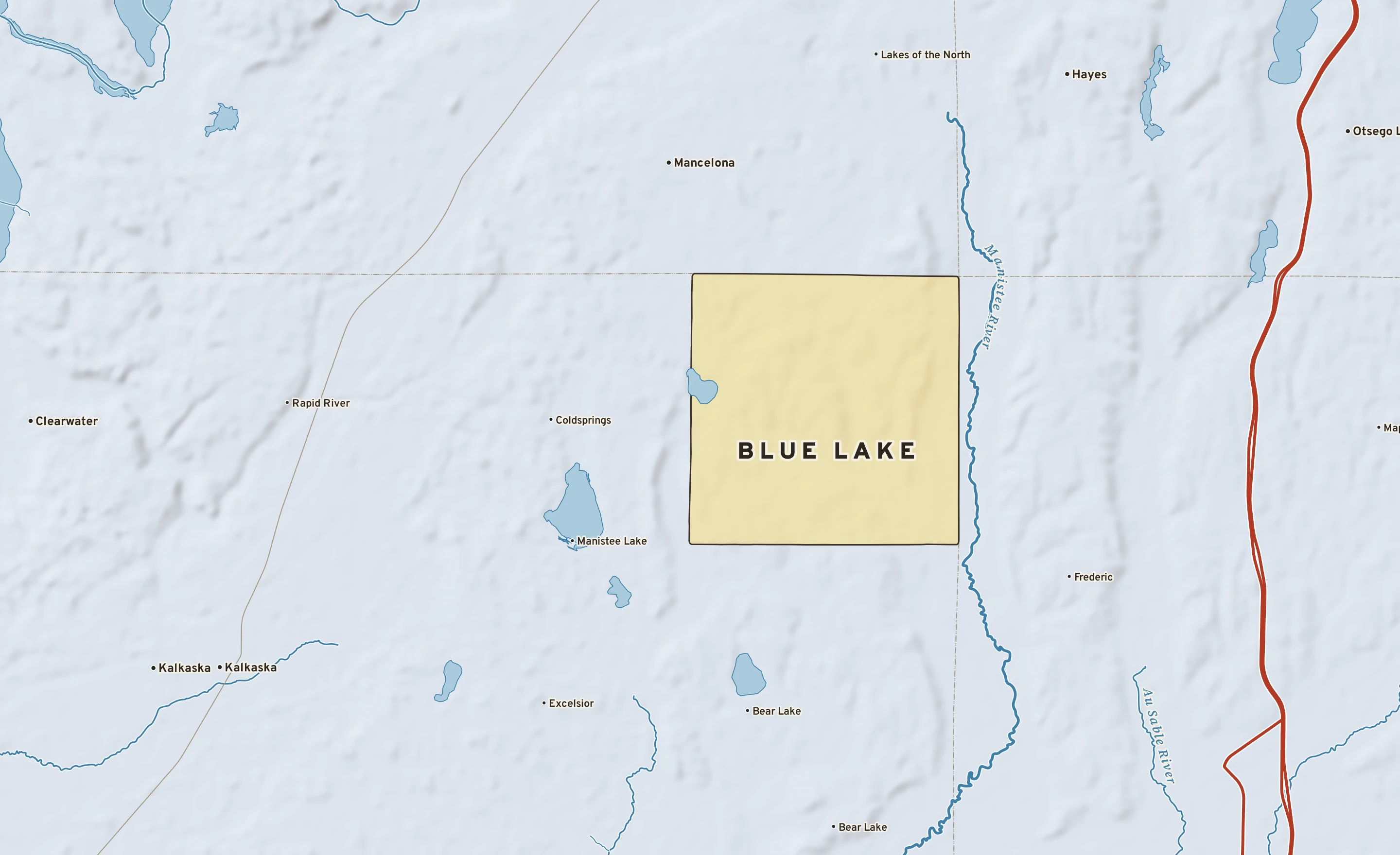 Shaded-relief atlas plate of Blue Lake, Michigan: rivers, roads, the city limits and where the water drains.