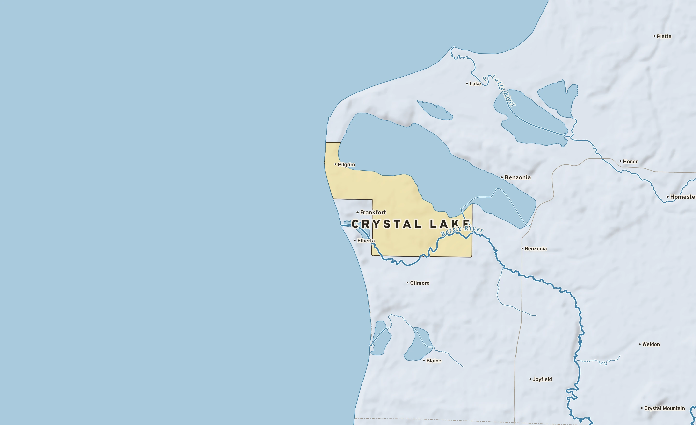 Shaded-relief atlas plate of Crystal Lake, Michigan: rivers, roads, the city limits and where the water drains.