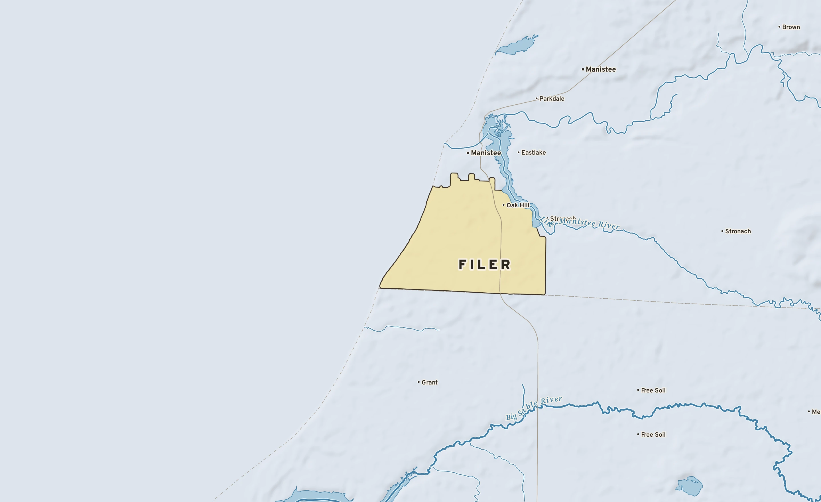 Shaded-relief atlas plate of Filer, Michigan: rivers, roads, the city limits and where the water drains.