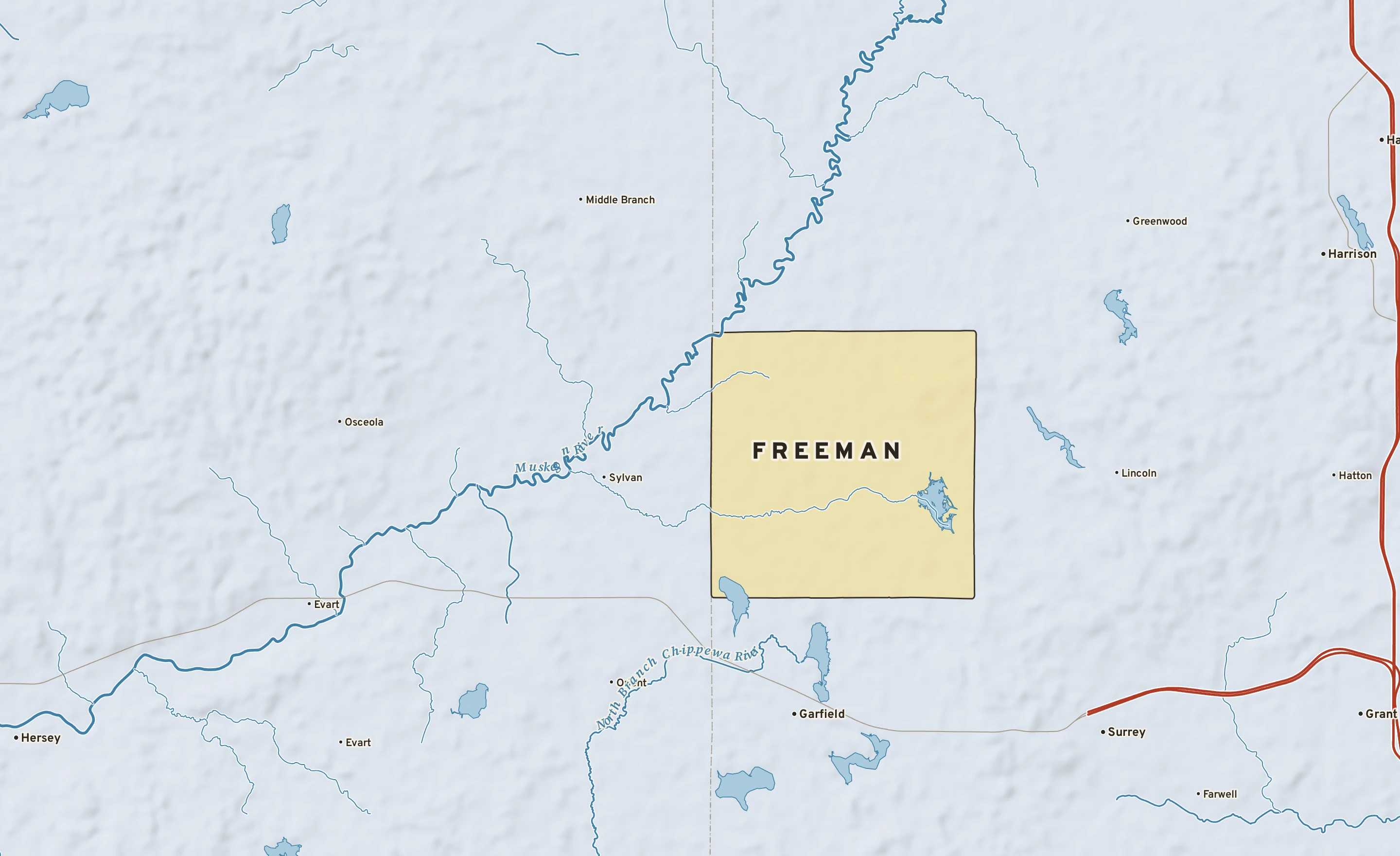 Shaded-relief atlas plate of Freeman, Michigan: rivers, roads, the city limits and where the water drains.