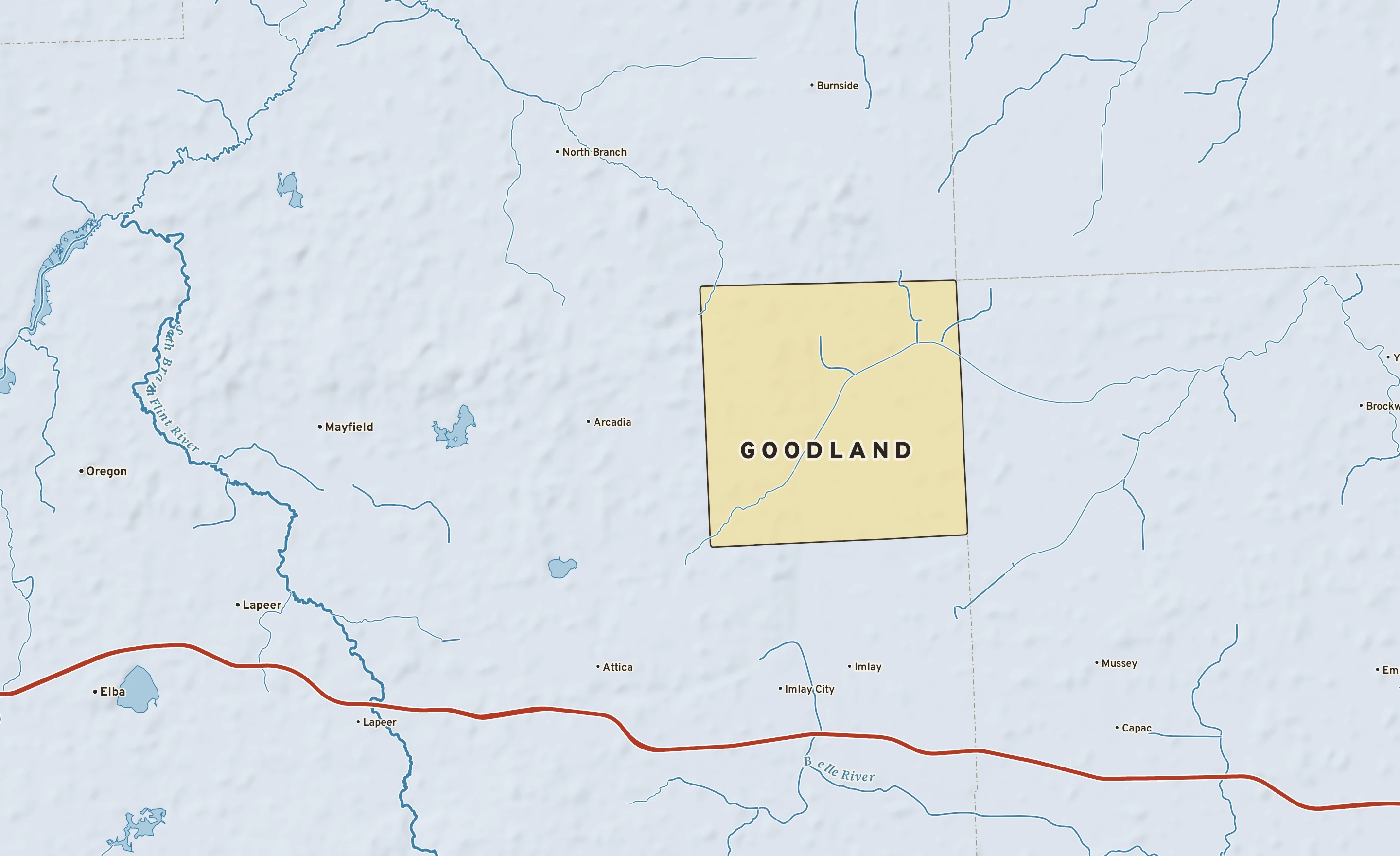 Shaded-relief atlas plate of Goodland, Michigan: rivers, roads, the city limits and where the water drains.
