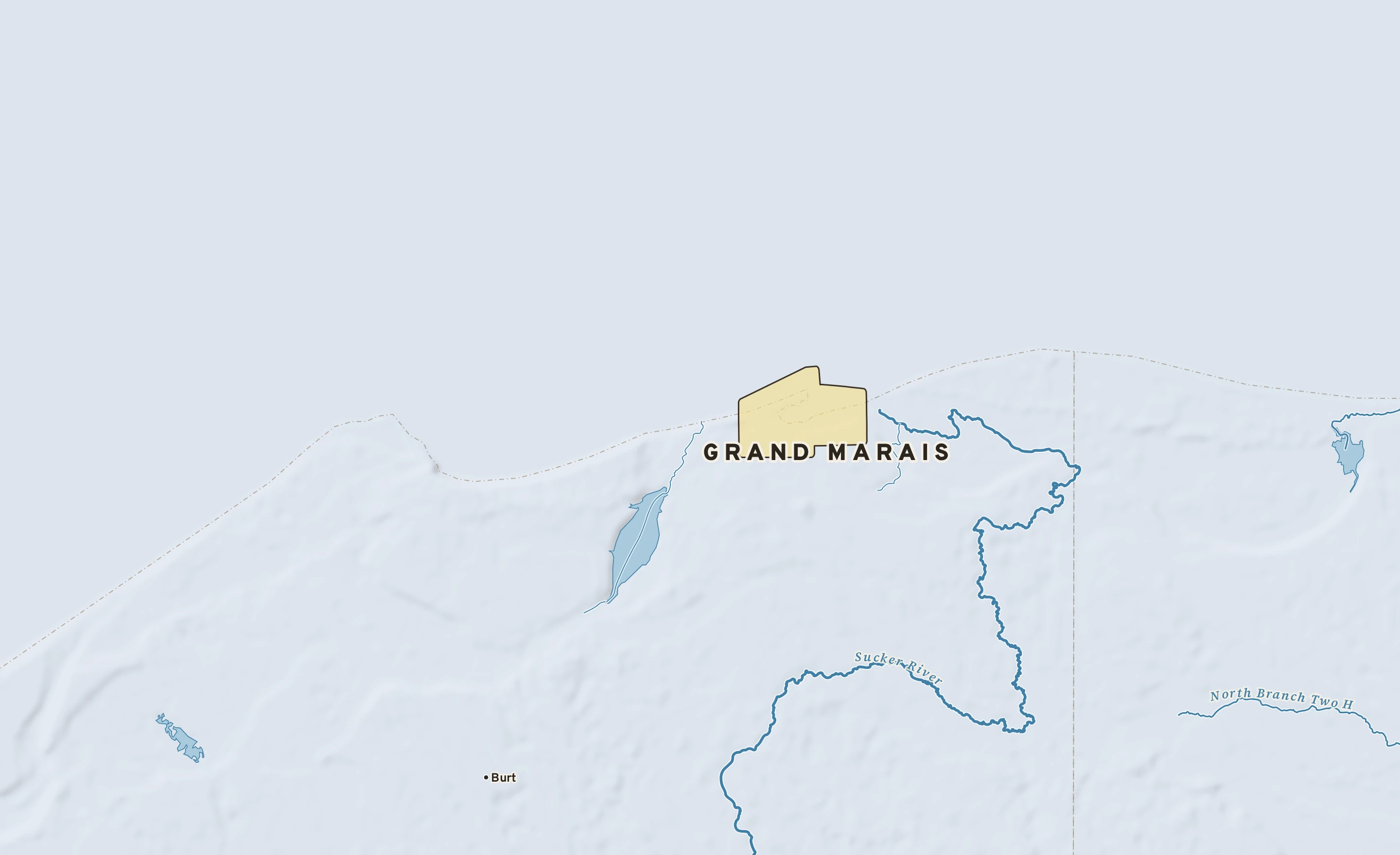 Shaded-relief atlas plate of Grand Marais, Michigan: rivers, roads, the city limits and where the water drains.