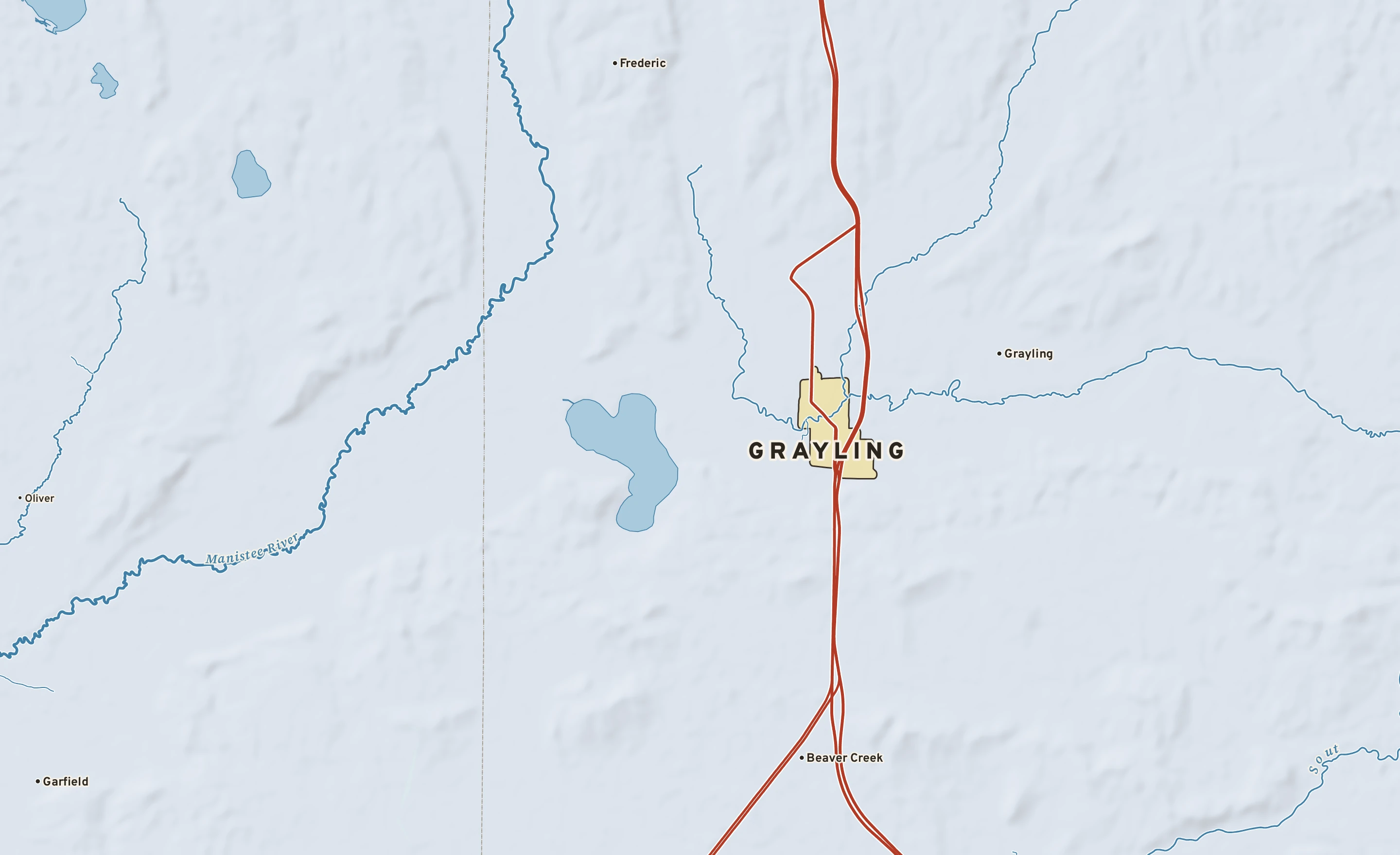 Shaded-relief atlas plate of Grayling, Michigan: rivers, roads, the city limits and where the water drains.