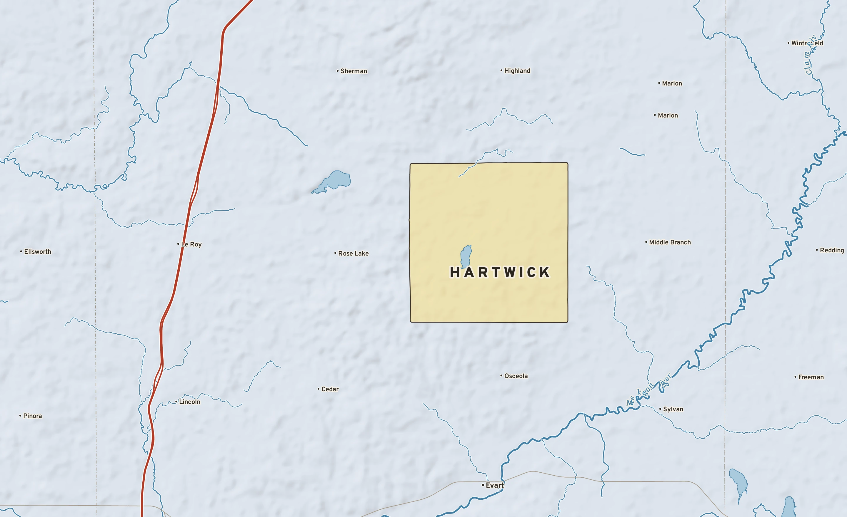 Shaded-relief atlas plate of Hartwick, Michigan: rivers, roads, the city limits and where the water drains.