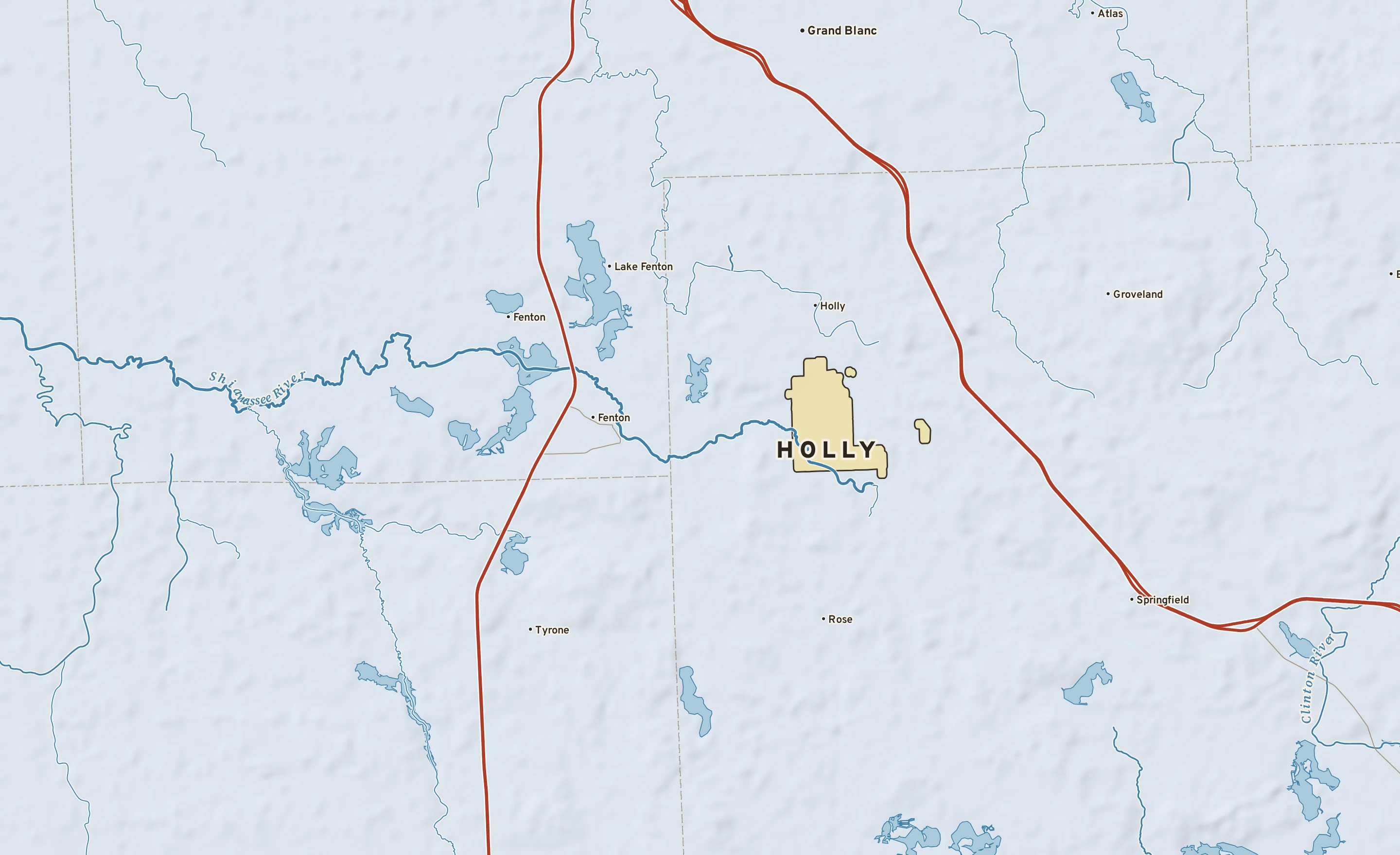 Shaded-relief atlas plate of Holly, Michigan: rivers, roads, the city limits and where the water drains.