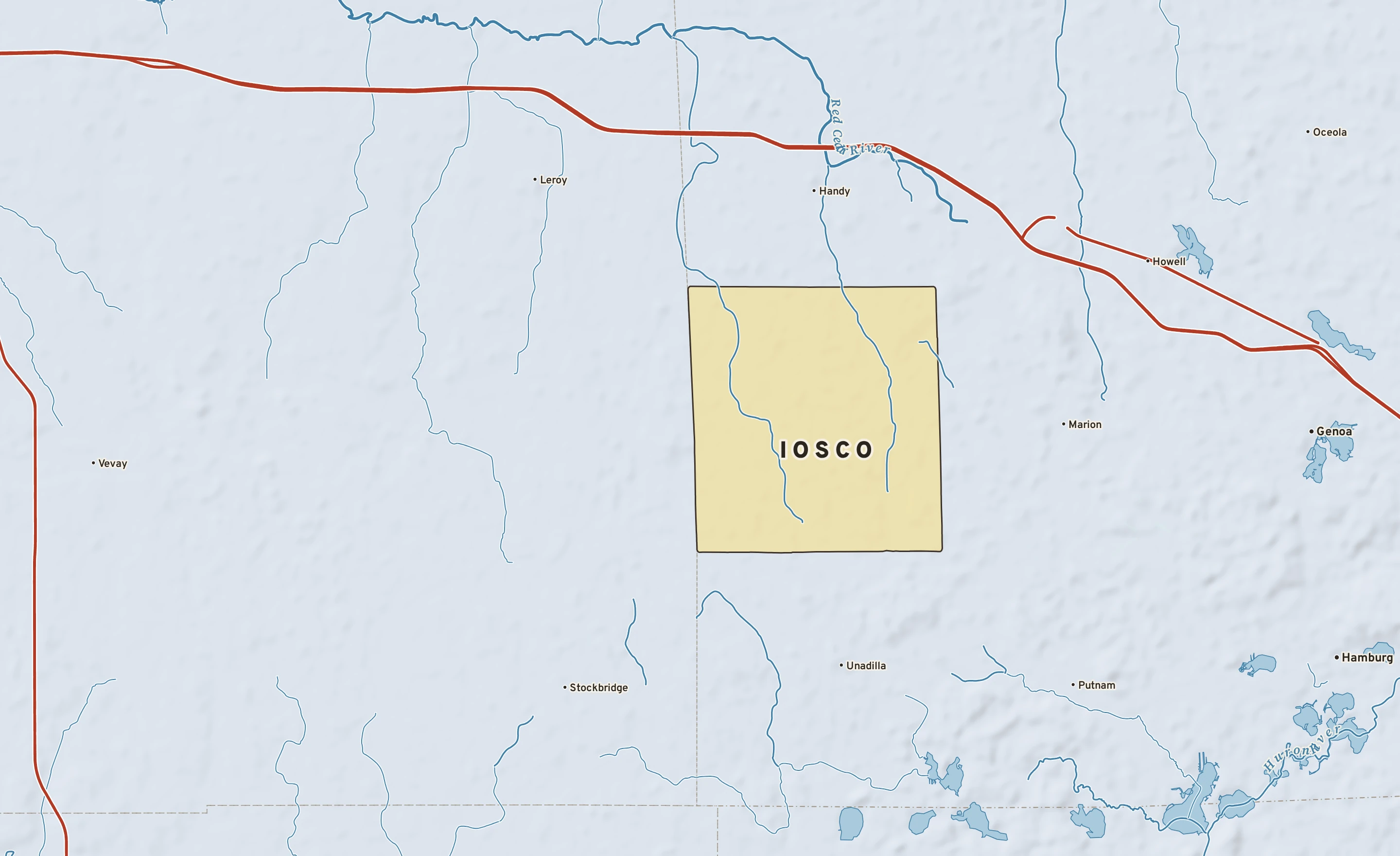 Shaded-relief atlas plate of Iosco, Michigan: rivers, roads, the city limits and where the water drains.