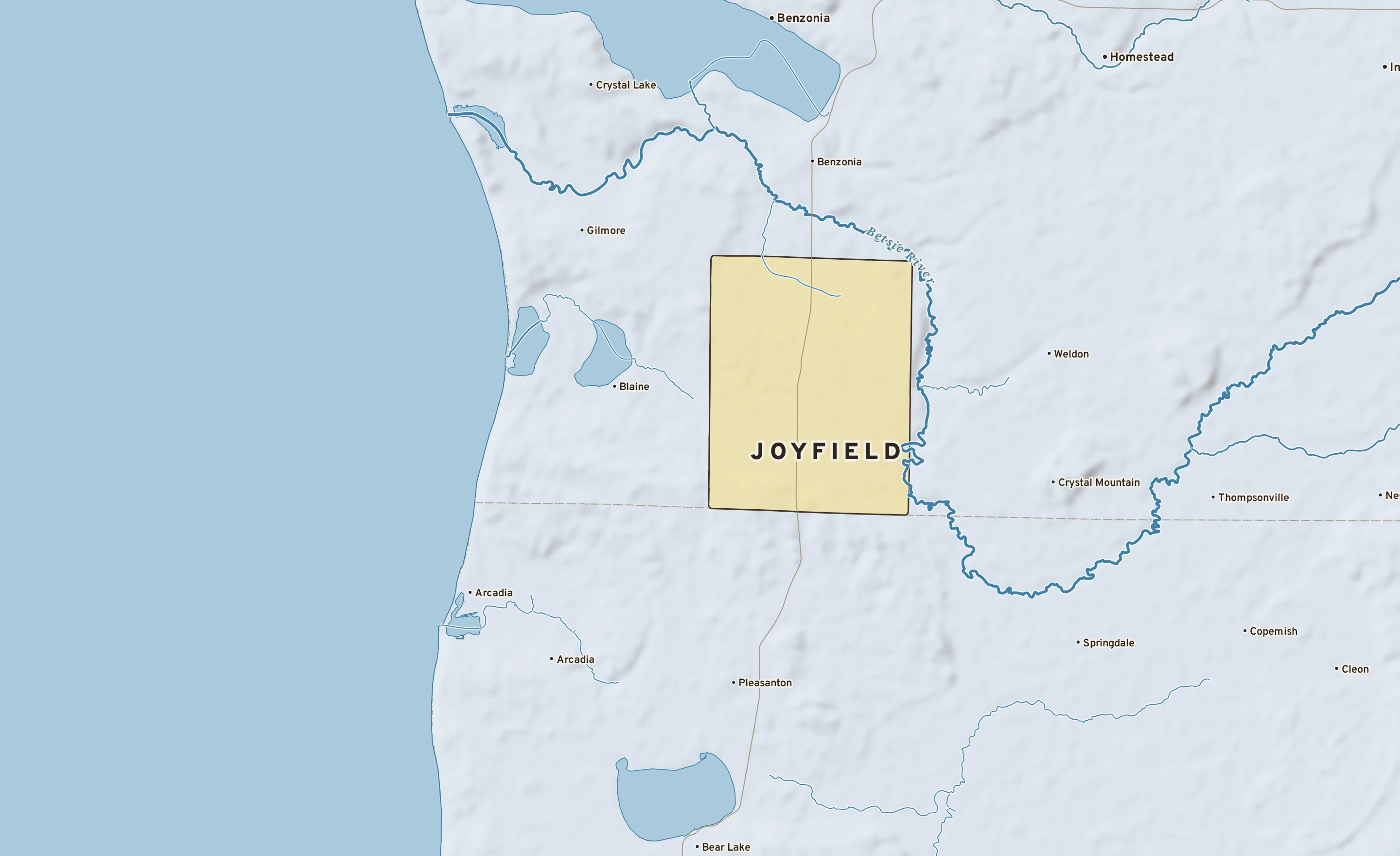 Shaded-relief atlas plate of Joyfield, Michigan: rivers, roads, the city limits and where the water drains.