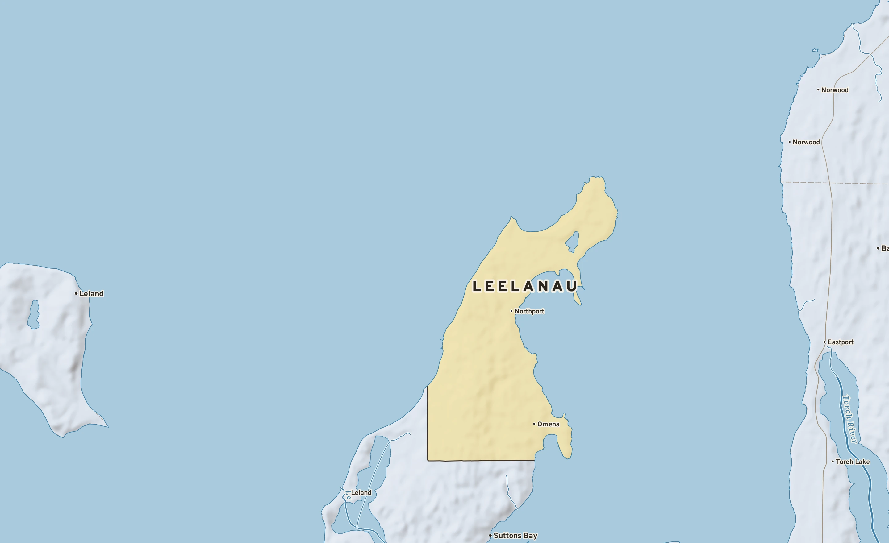 Shaded-relief atlas plate of Leelanau, Michigan: rivers, roads, the city limits and where the water drains.
