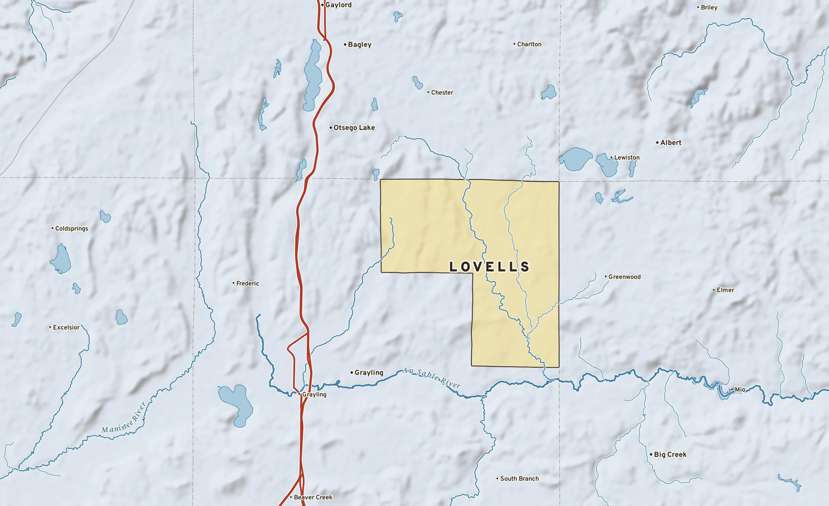 Shaded-relief atlas plate of Lovells, Michigan: rivers, roads, the city limits and where the water drains.