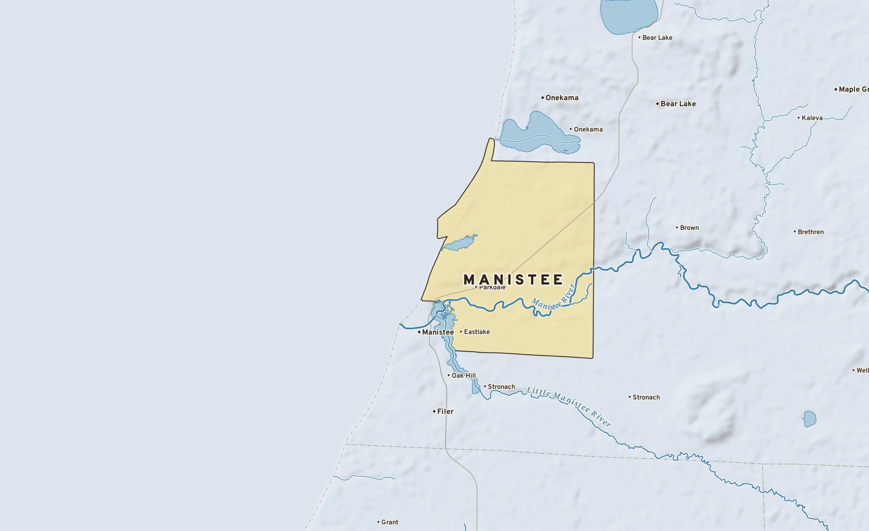Shaded-relief atlas plate of Manistee, Michigan: rivers, roads, the city limits and where the water drains.