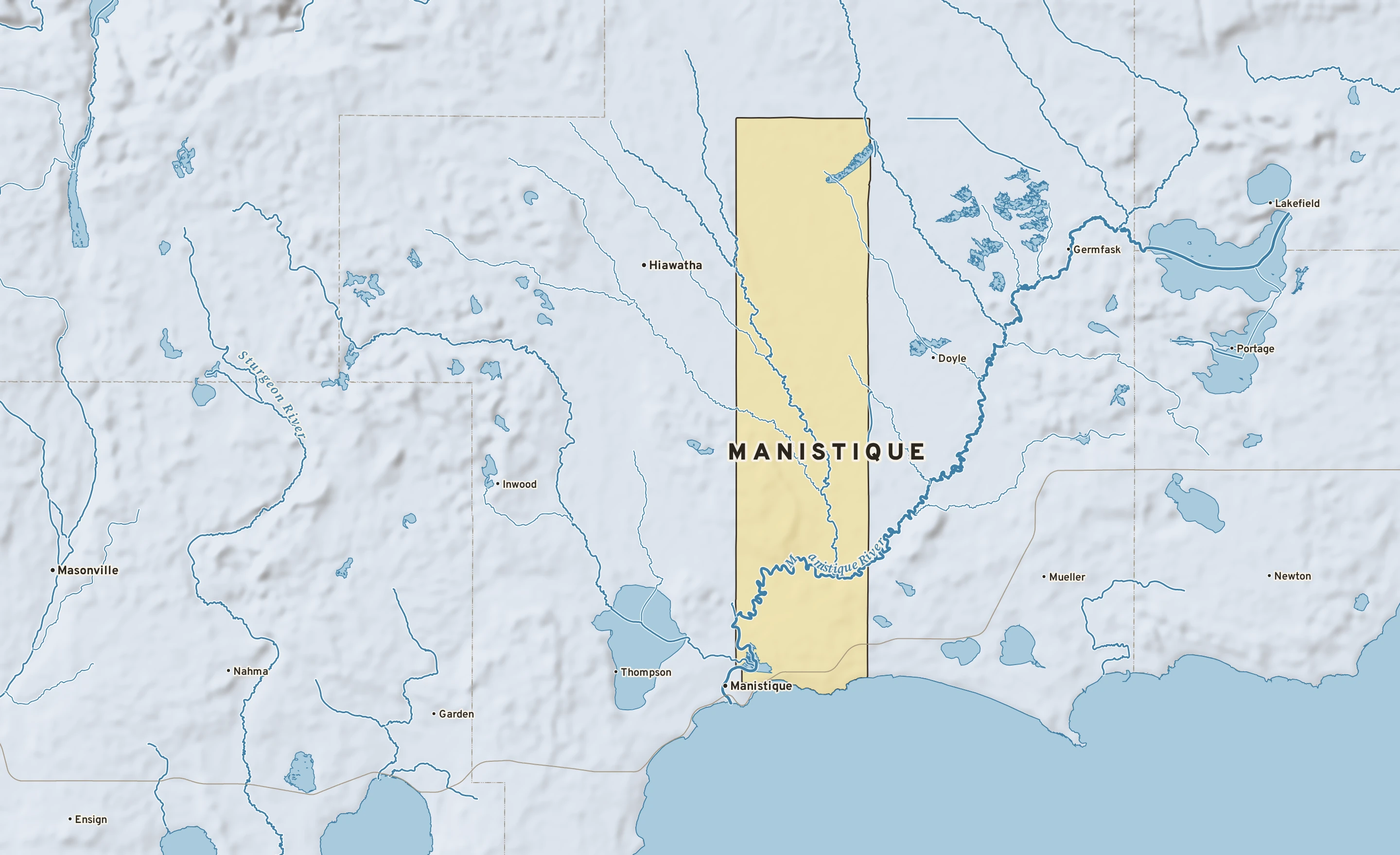 Shaded-relief atlas plate of Manistique, Michigan: rivers, roads, the city limits and where the water drains.