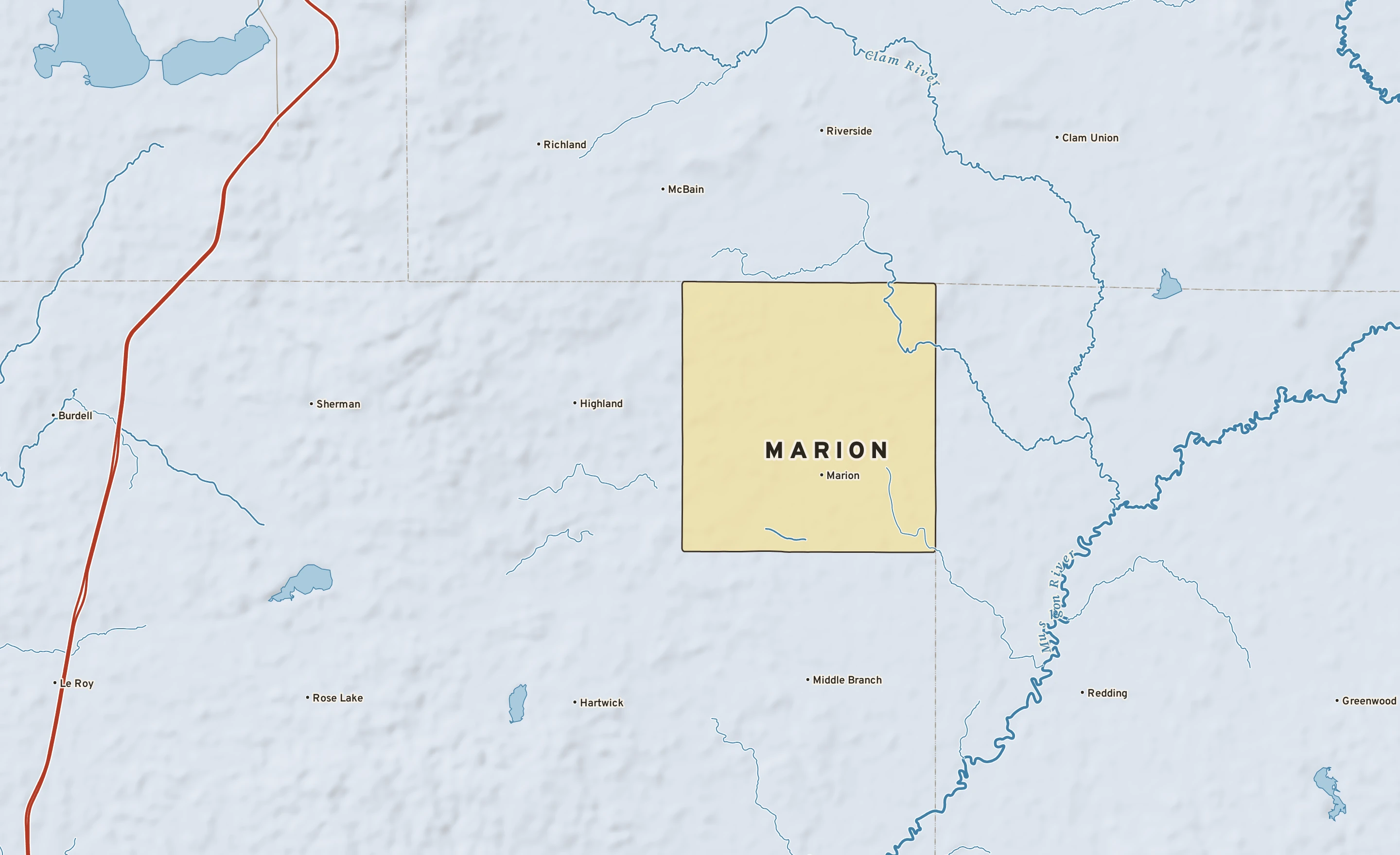 Shaded-relief atlas plate of Marion, Michigan: rivers, roads, the city limits and where the water drains.