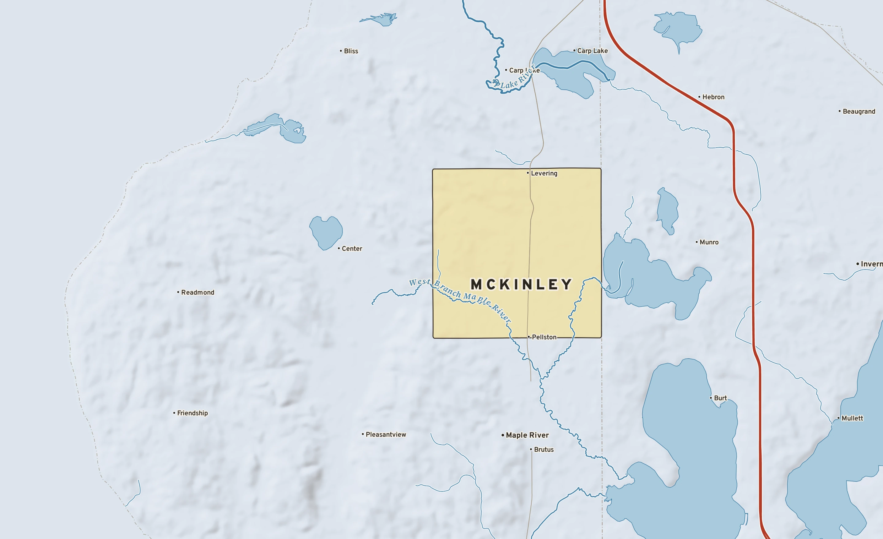 Shaded-relief atlas plate of McKinley, Michigan: rivers, roads, the city limits and where the water drains.