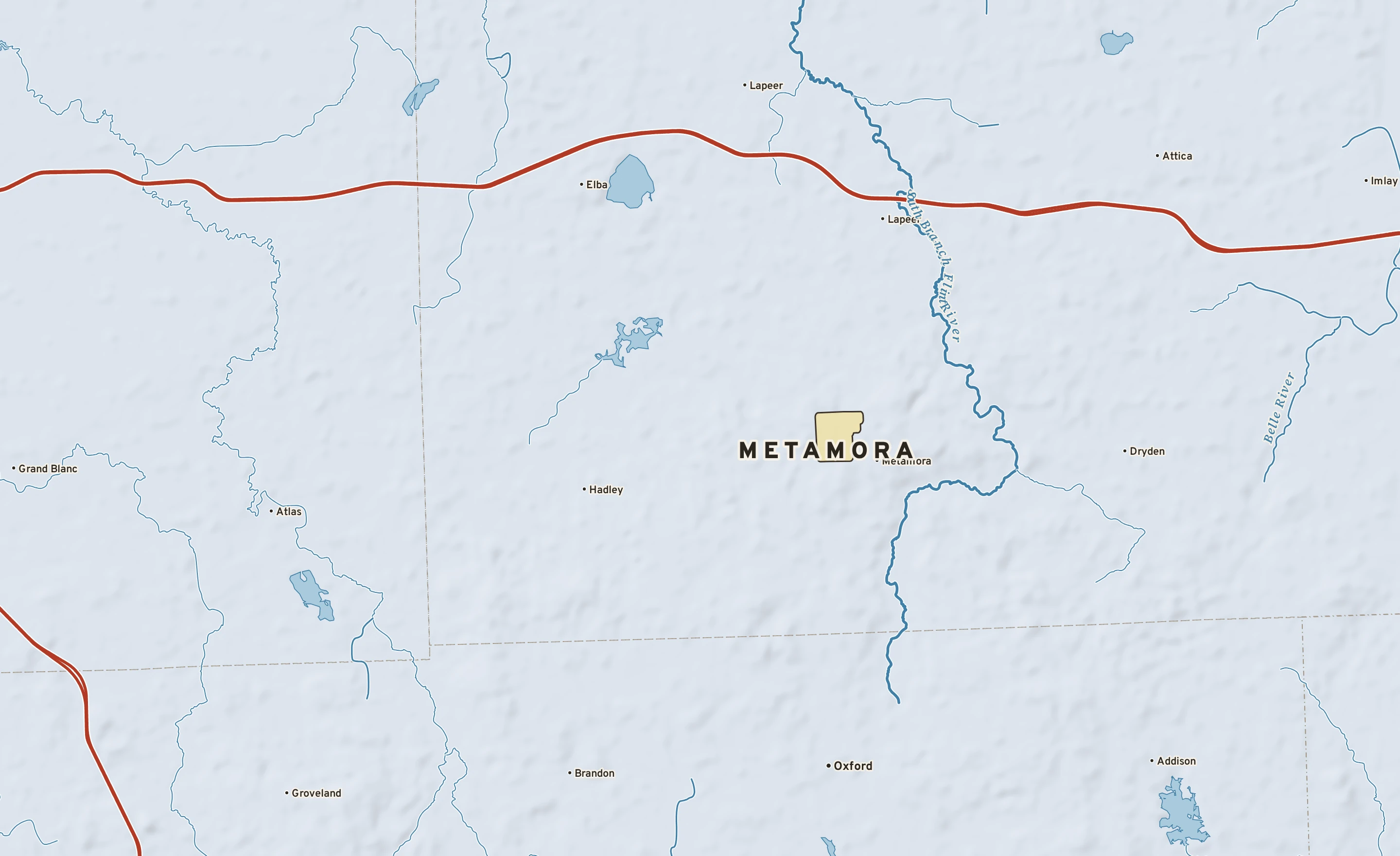 Shaded-relief atlas plate of Metamora, Michigan: rivers, roads, the city limits and where the water drains.
