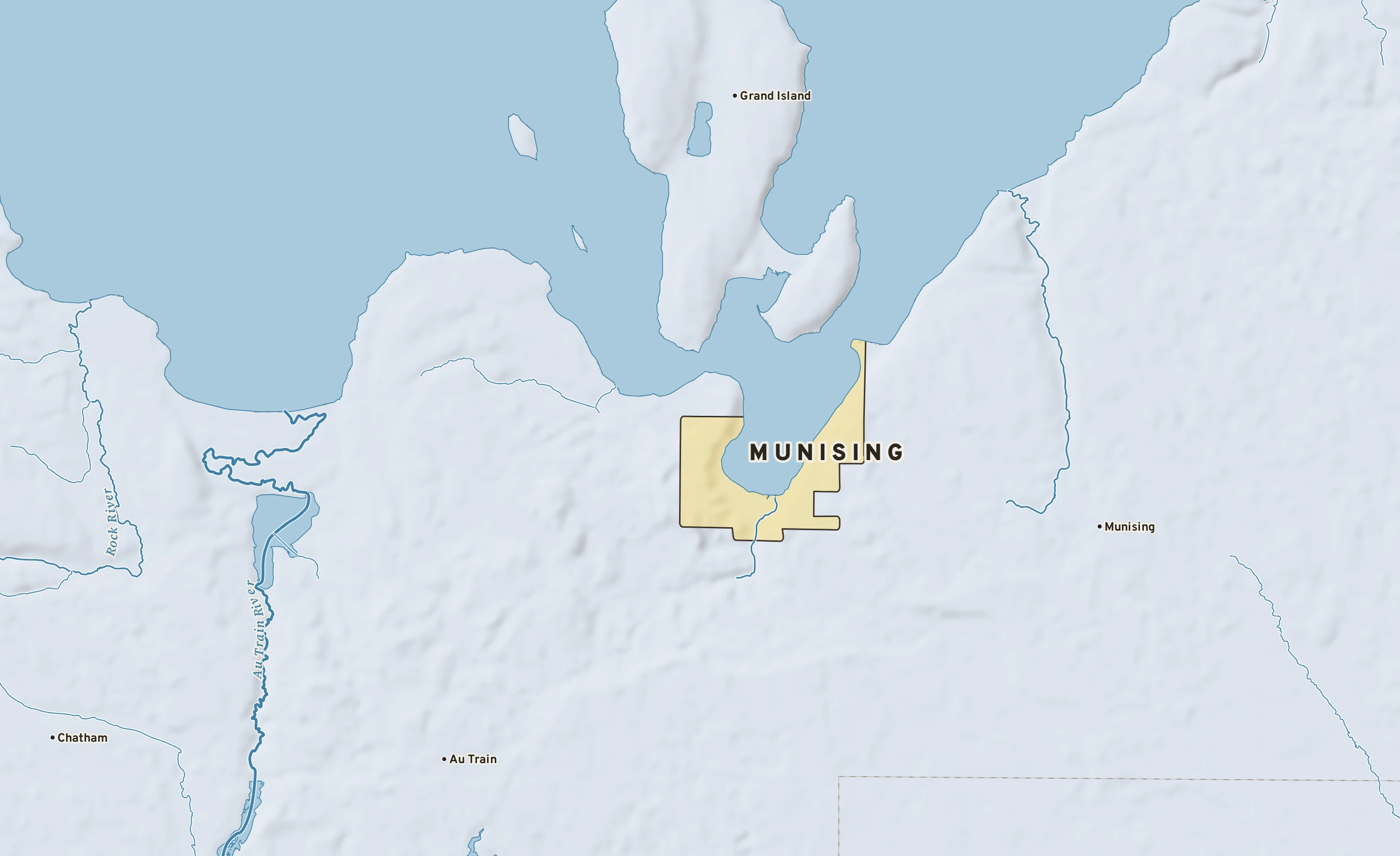 Shaded-relief atlas plate of Munising, Michigan: rivers, roads, the city limits and where the water drains.