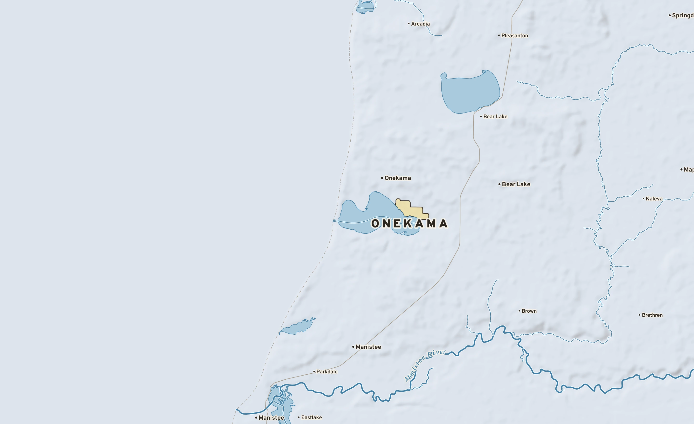 Shaded-relief atlas plate of Onekama, Michigan: rivers, roads, the city limits and where the water drains.