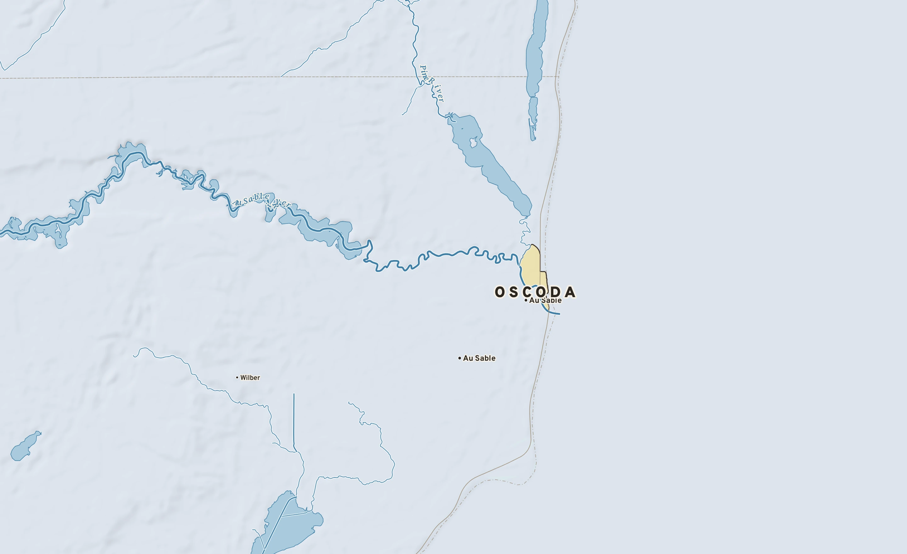 Shaded-relief atlas plate of Oscoda, Michigan: rivers, roads, the city limits and where the water drains.