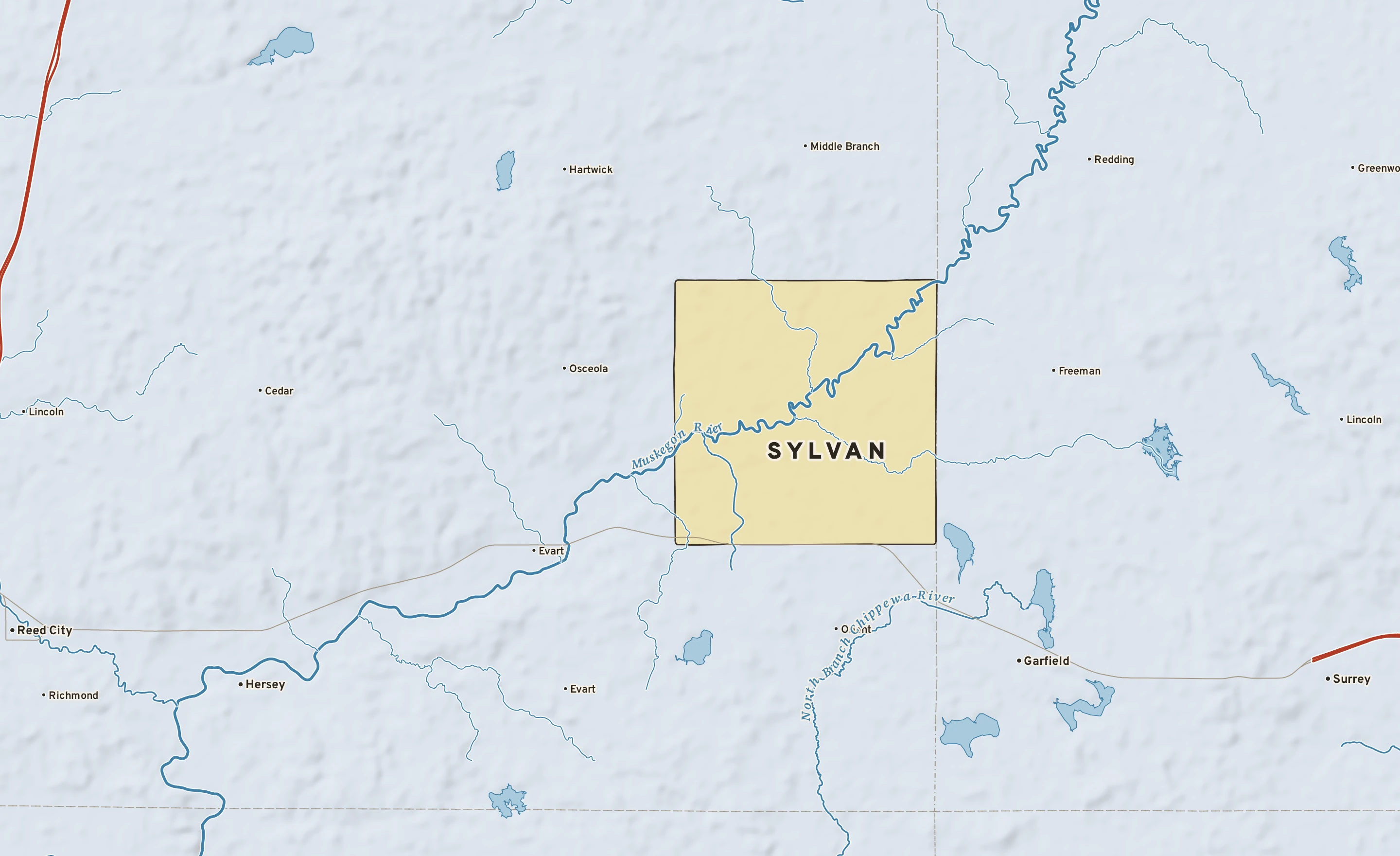Shaded-relief atlas plate of Sylvan, Michigan: rivers, roads, the city limits and where the water drains.
