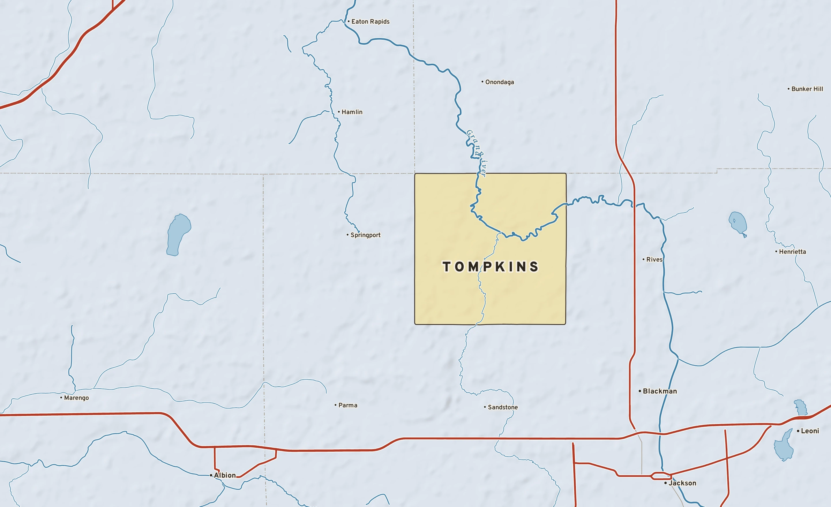 Shaded-relief atlas plate of Tompkins, Michigan: rivers, roads, the city limits and where the water drains.