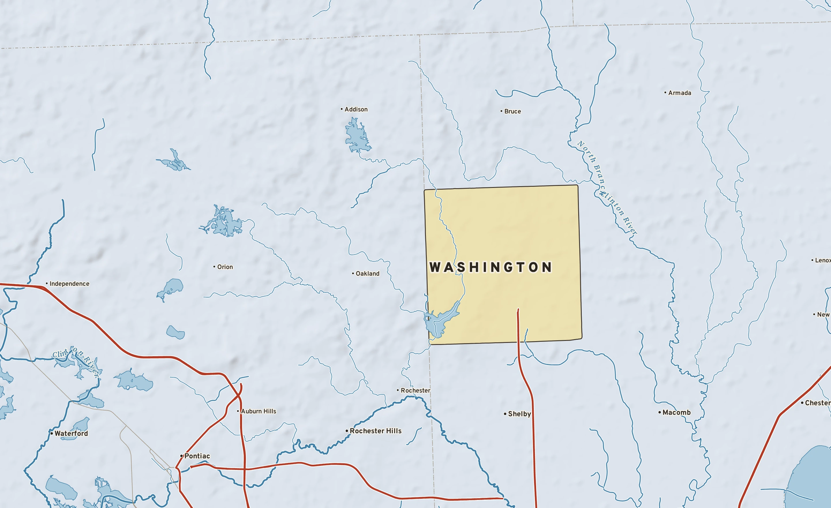 Shaded-relief atlas plate of Washington, Michigan: rivers, roads, the city limits and where the water drains.