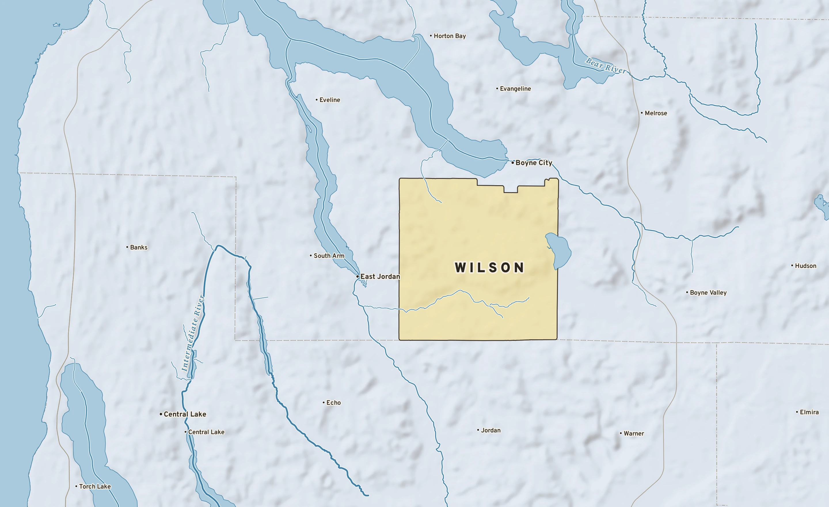 Shaded-relief atlas plate of Wilson, Michigan: rivers, roads, the city limits and where the water drains.