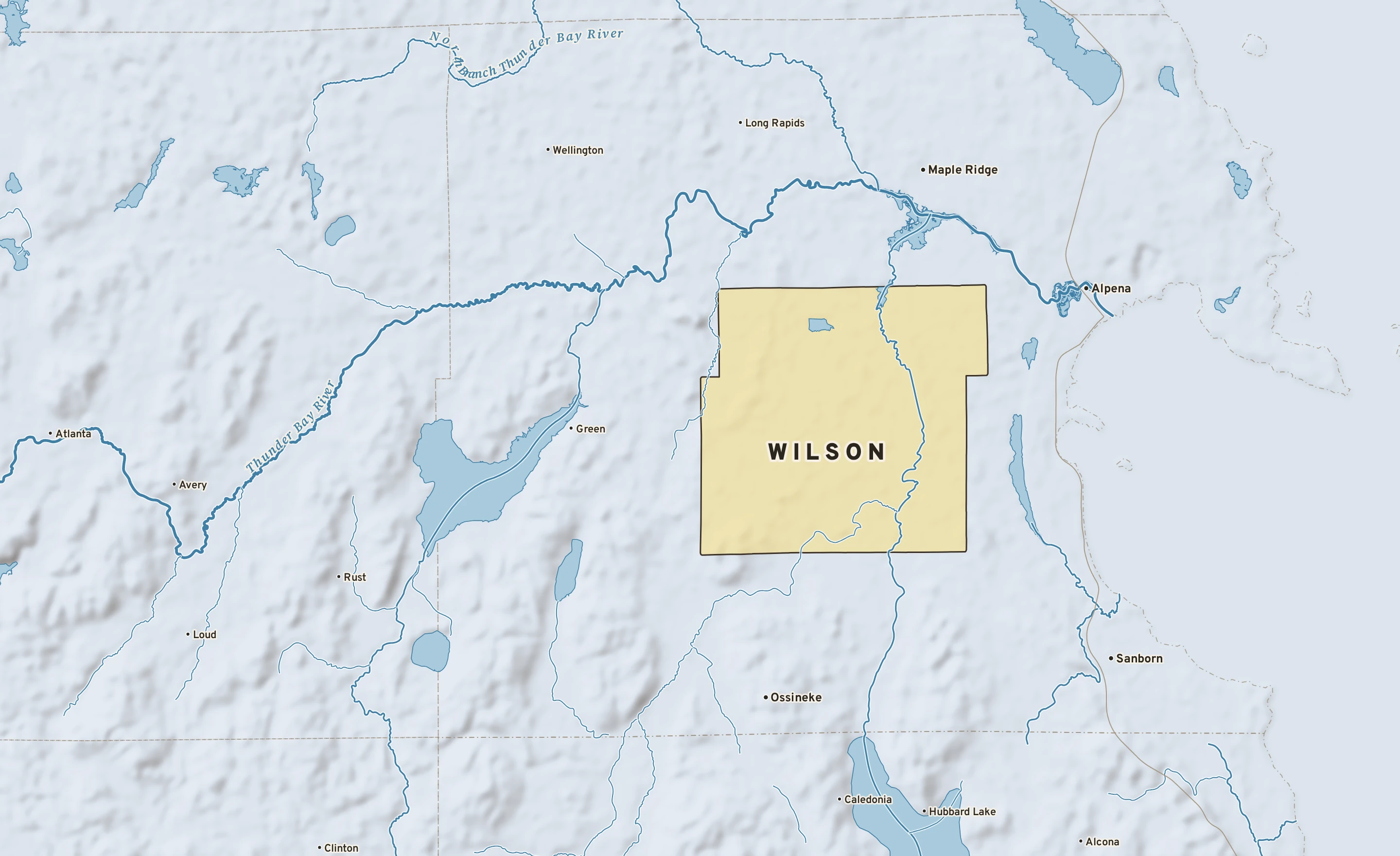 Shaded-relief atlas plate of Wilson, Michigan: rivers, roads, the city limits and where the water drains.