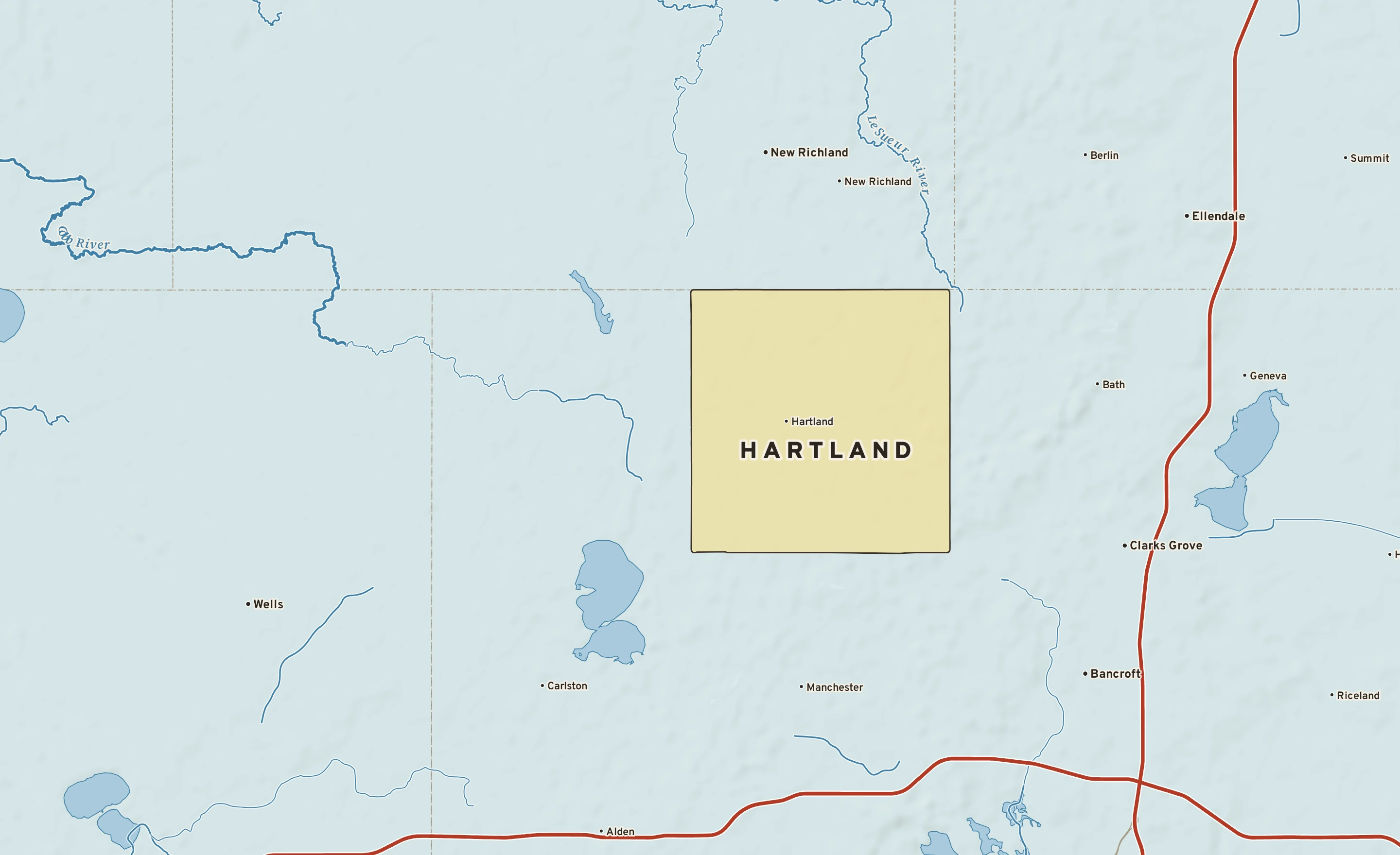 Shaded-relief atlas plate of Hartland, Minnesota: rivers, roads, the city limits and where the water drains.