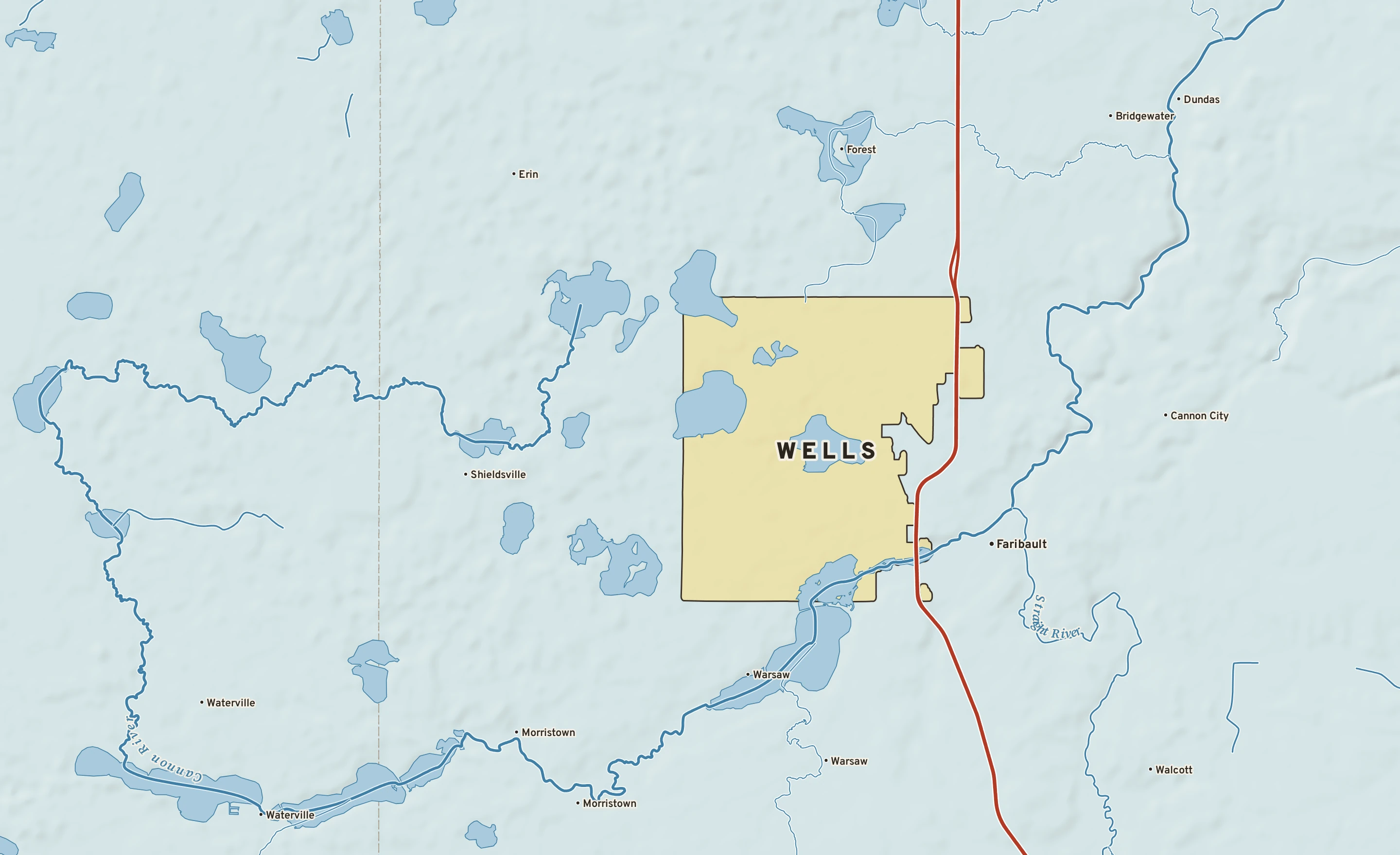 Shaded-relief atlas plate of Wells, Minnesota: rivers, roads, the city limits and where the water drains.