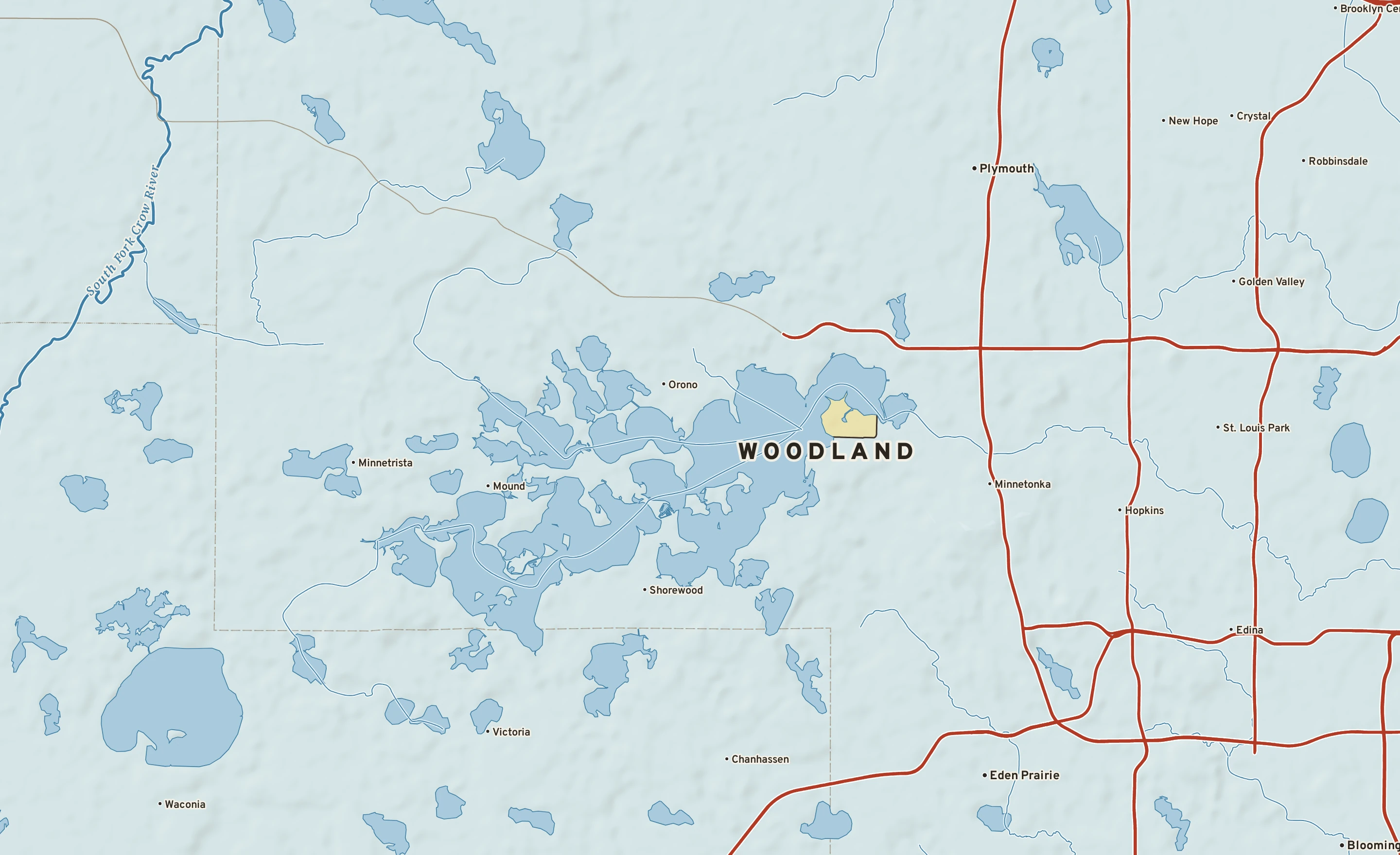 Shaded-relief atlas plate of Woodland, Minnesota: rivers, roads, the city limits and where the water drains.