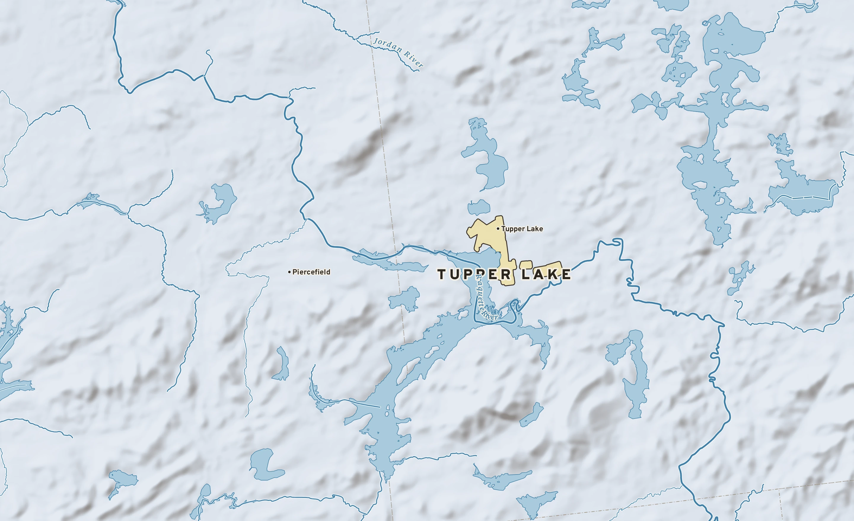 Shaded-relief atlas plate of Tupper Lake, New York: rivers, roads, the city limits and where the water drains.