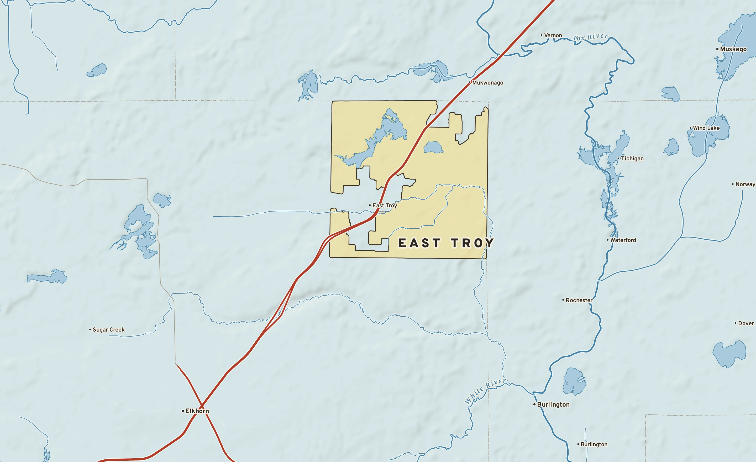 Shaded-relief atlas plate of East Troy, Wisconsin: rivers, roads, the city limits and where the water drains.