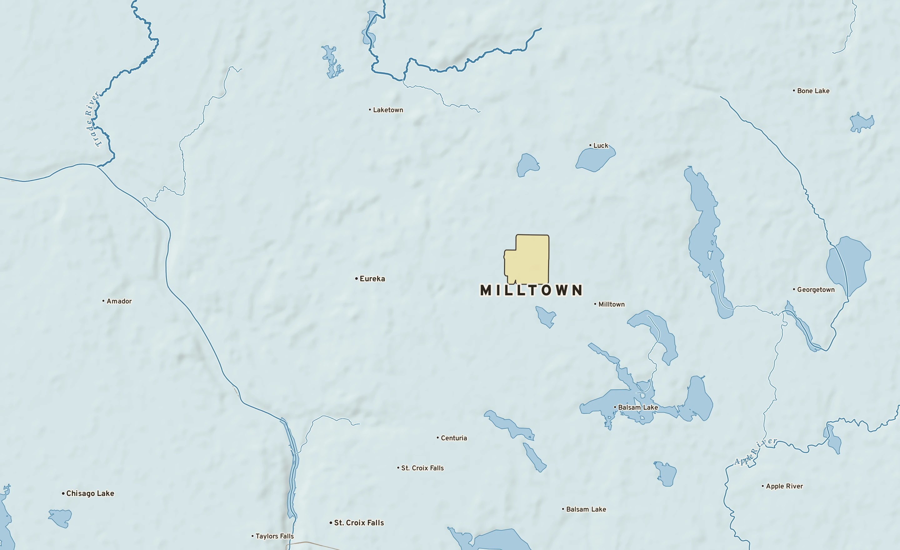 Shaded-relief atlas plate of Milltown, Wisconsin: rivers, roads, the city limits and where the water drains.