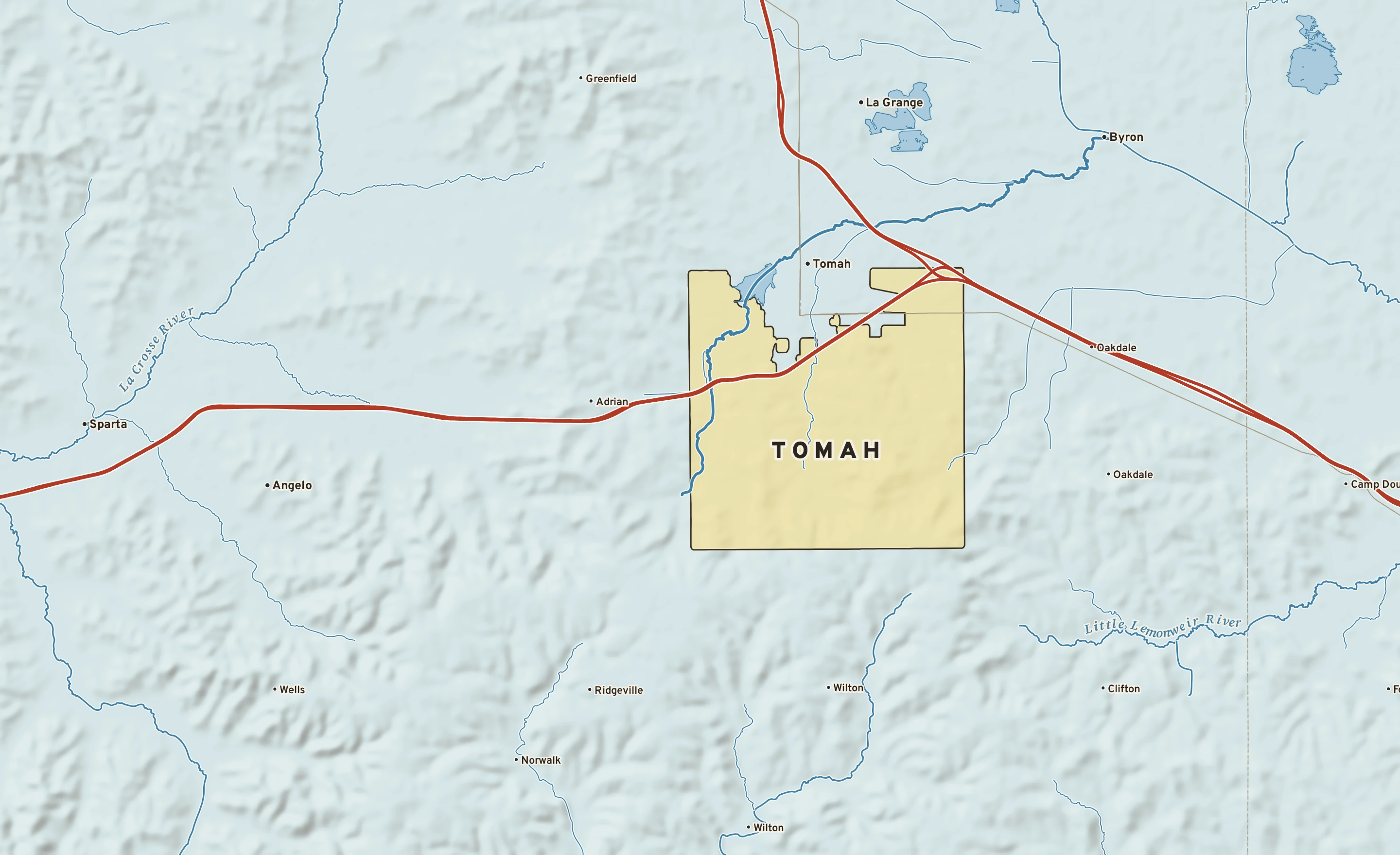 Shaded-relief atlas plate of Tomah, Wisconsin: rivers, roads, the city limits and where the water drains.